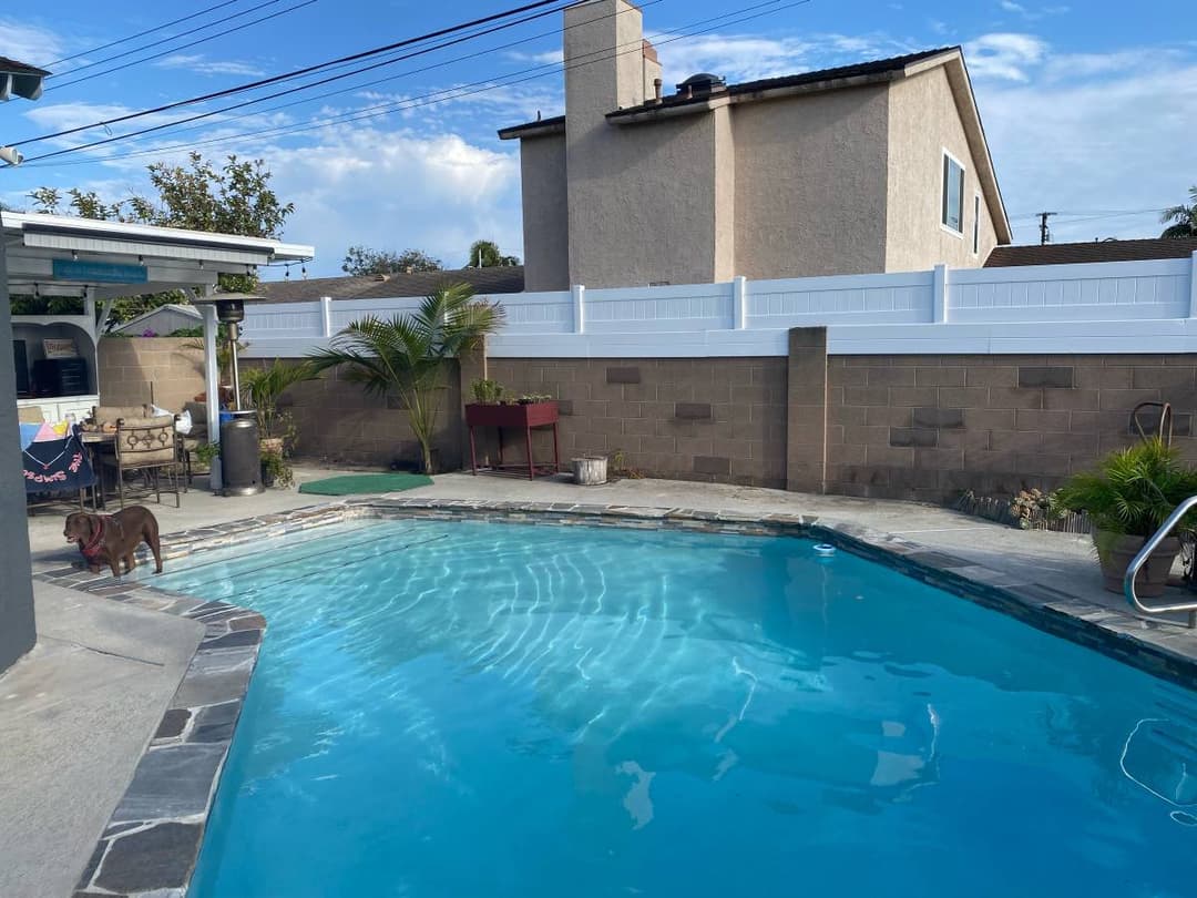 white vinyl fence separating two homes