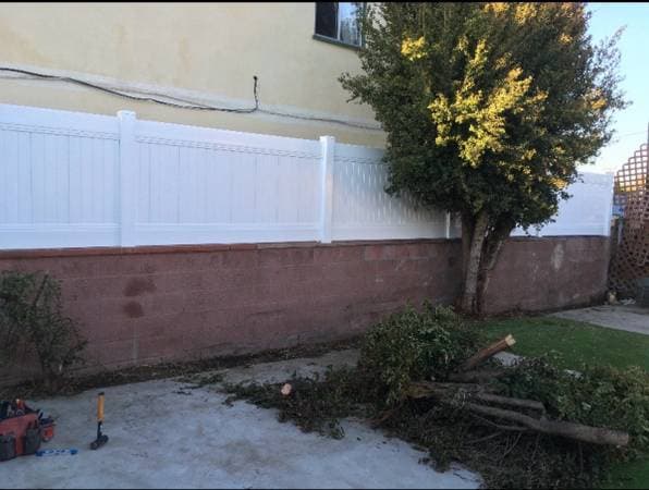 white vinyl fence on top of a brick foundation