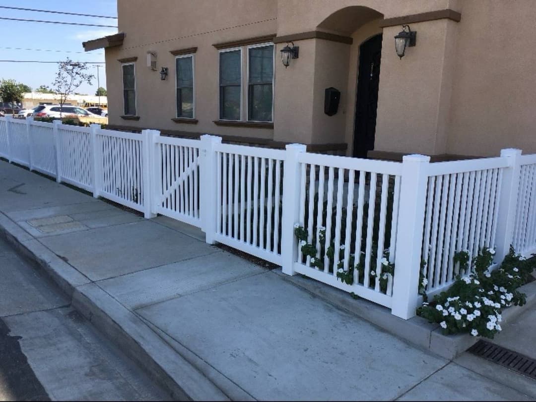 white picket fence surrounding the front of a home